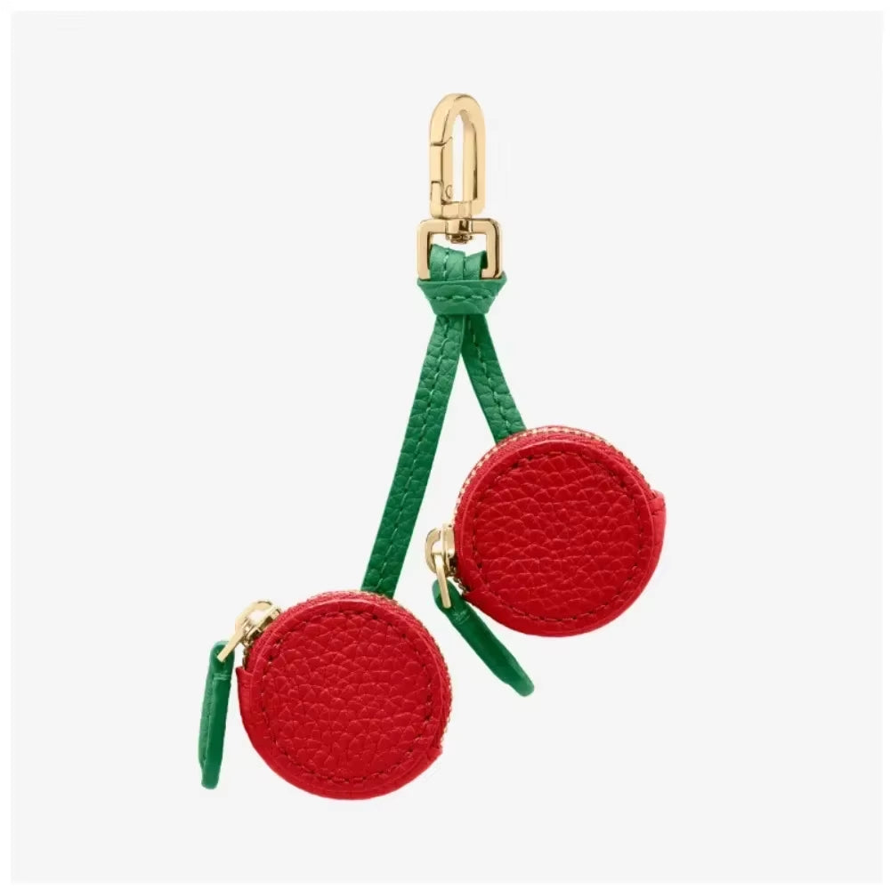 Red circular pouches with green straps and gold clasps on a white background